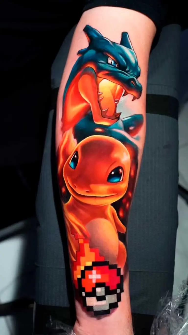 Charmander & Charizard color realism tattoo on forearm by Pablo Frias
